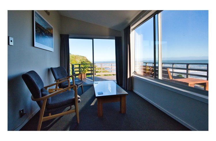 Kowhai room upstairs in main house sitting area with balcony and views to Tasman Sea
