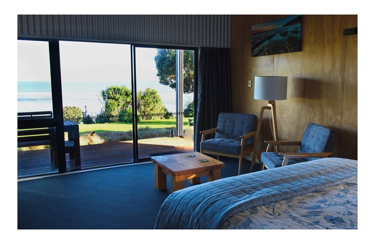 Nikau room sitting & bed area with views to gardens and Sea Breakers Boutique Accommodation, West Coast, New Zealand