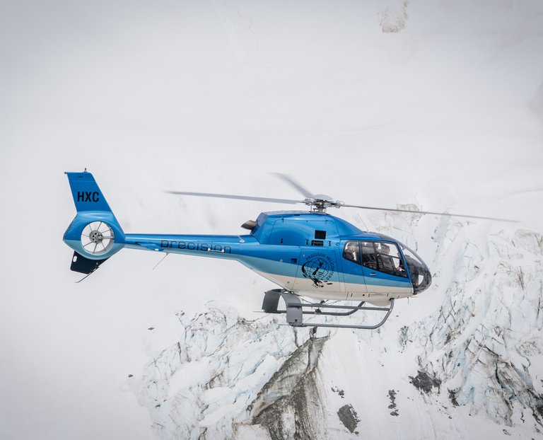 Precision Helicopters flying above a West Coast glacier